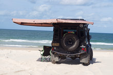Load image into Gallery viewer, GEORGE4X4 270 Free Standing Awning perfect for smaller vehicles like the Suzuki Jimny, Jeep Wrangler, and Defender 90
Built-in LED Lighting: Illuminate your campsite with integrated LED lights powered by a 5m USB cable. Optimal Dimensions: 2m length with a 2m radius—small enough to be versatile, yet spacious enough for comfort. Durable Material: Made from rugged 280g polycotton canvas, ensuring waterproof protection and durability. Lightweight Design: Weighs only 23kg, making it easy to transport and set up